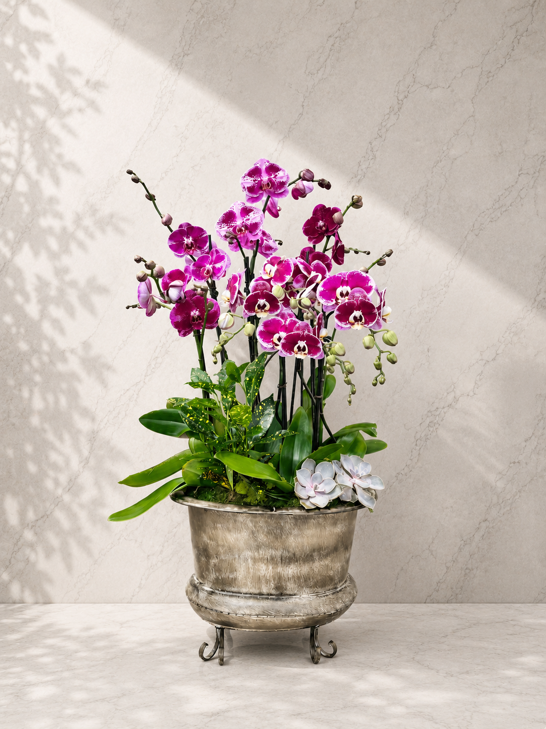 Introduce grand, vintage elegance with the Magenta Luxe Antique Garden by Flora Clay. Rich magenta patterned orchids set in a classic footed metal planter.
