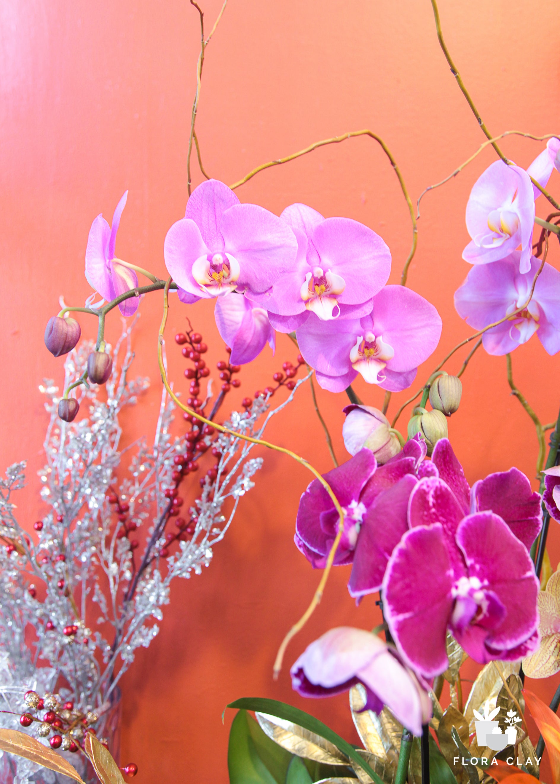purple pink orchid arrangement in a wooden pot